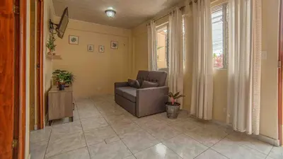 a living room with a chair and a window at Fortuna Flat Walk & Value in Fortuna