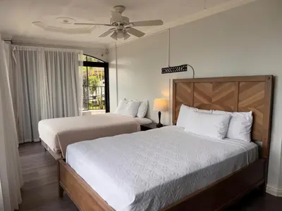 a bedroom with two beds and a ceiling fan at Casa Escazu Overlook in San Antonio
