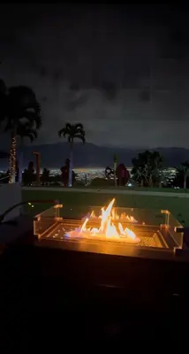 a fire pit with flames in the middle of a field at Casa Escazu Overlook in San Antonio