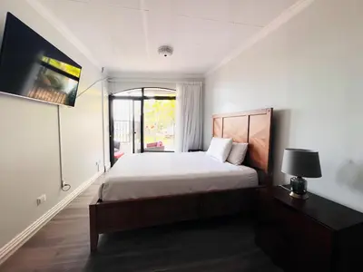 a bedroom with a large bed and a window at Casa Escazu Overlook in San Antonio