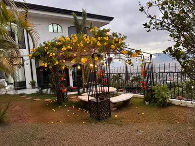 a garden with a bench and flowers in front of a house at Casa Escazu Overlook in San Antonio