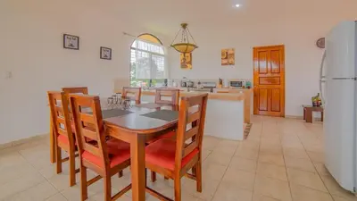 a kitchen with a table and chairs and a refrigerator at Oasis 17 , Group Getaway in Fortuna