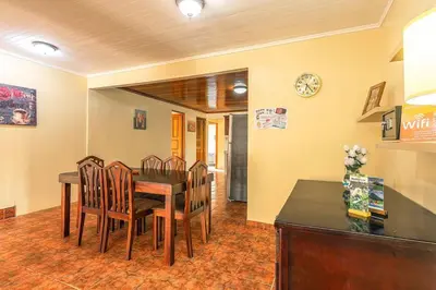 a dining room with a table and chairs and a clock at Oasis 17 , Group Getaway in Fortuna
