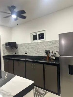 a kitchen with a refrigerator and a ceiling fan at Loft en San José de pinilla avellanas guanacaste in San José Pinilla