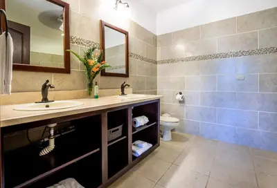 a bathroom with two sinks and a toilet at Luxury Villa Bijagual Costa Rica in Carara