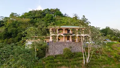 a house on the side of a hill at Luxury Villa Bijagual Costa Rica in Carara