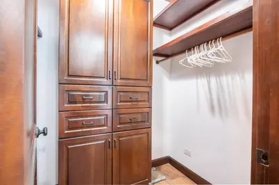 a closet with wooden cabinets in a room at Luxury Villa Bijagual Costa Rica in Carara