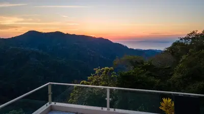 a view of a mountain at sunset from a balcony at Luxury Villa Bijagual Costa Rica in Carara