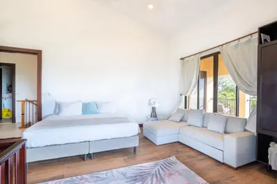 a bedroom with a bed and a couch at Luxury Villa Bijagual Costa Rica in Carara