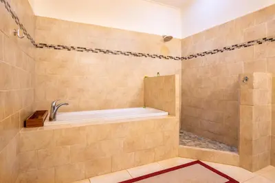 a bathroom with a tub and a shower at Luxury Villa Bijagual Costa Rica in Carara