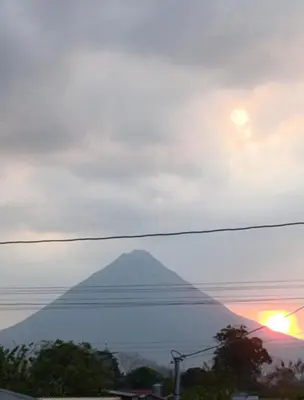 a view of a pyramid in the distance with a sunset at Coral House Fortuna in Tanque