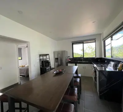 a kitchen with a large wooden table in a room at Casa Cascada La Roca in Sámara