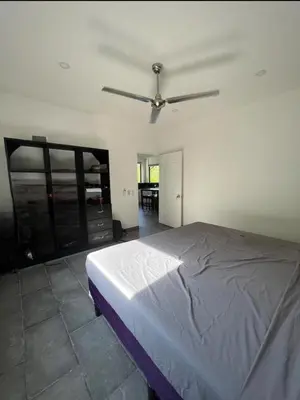 a bedroom with a bed and a ceiling fan at Casa Cascada La Roca in Sámara