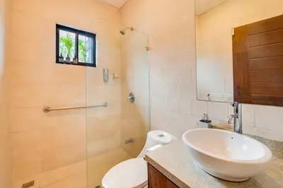 a bathroom with a sink and a toilet and a shower at Casa Fabali in Tamarindo