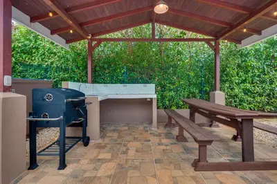 a patio with a grill and a picnic table at Casa Fabali in Tamarindo