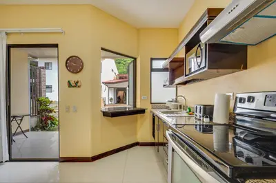 a kitchen with a sink and a stove at Casa Luna in Carpintero