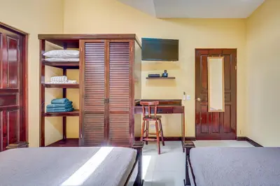 a bedroom with a bed and a table with a stool at Casa Luna in Carpintero