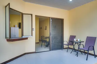 a room with chairs and a table with a mirror at Casa Luna in Carpintero