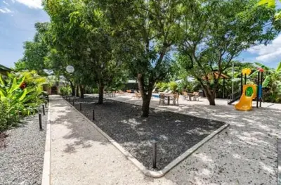 a park with a playground with trees and a yellow slide at Luxury 2BR Villa by Tamarindo, AC, Private Yard in Tamarindo