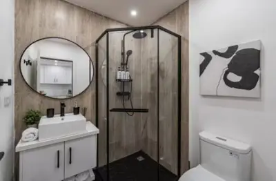 a bathroom with a toilet and a sink and a mirror at Luxury 2BR Villa by Tamarindo, AC, Private Yard in Tamarindo