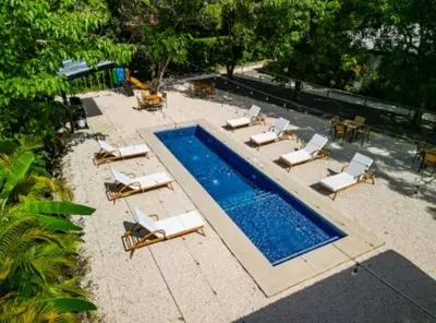 an overhead view of a swimming pool with chaise lounge chairs and a swimming pool at Luxury 2BR Villa by Tamarindo, AC, Private Yard in Tamarindo