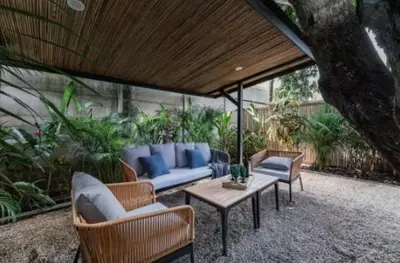 a patio with a blue couch and chairs and a table at Luxury 2BR Villa by Tamarindo, AC, Private Yard in Tamarindo