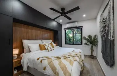 a bedroom with a large bed with a ceiling fan at Luxury 2BR Villa by Tamarindo, AC, Private Yard in Tamarindo