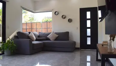 a living room with a couch and a table at CASA CEA-Swimming Pool Rancho SantaTeresa Malpais in San Isidro