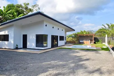 a small white house with a driveway at CASA CEA-Swimming Pool Rancho SantaTeresa Malpais in San Isidro
