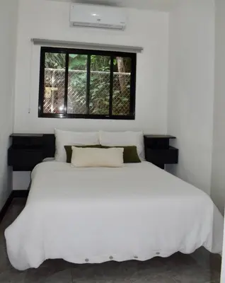 a white bed in a room with a window at CASA CEA-Swimming Pool Rancho SantaTeresa Malpais in San Isidro