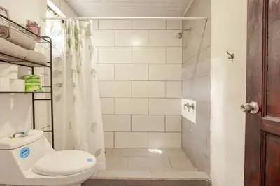 a bathroom with a toilet and a shower at Private Costa Rican Oasis with Pool River Views in Cóbano