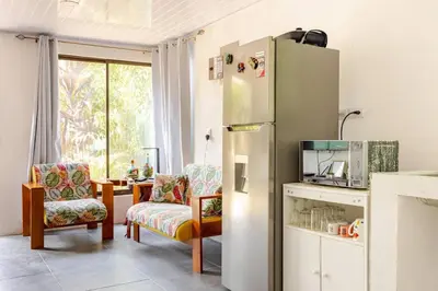 a kitchen with a refrigerator and a table with chairs at Private Costa Rican Oasis with Pool River Views in Cóbano