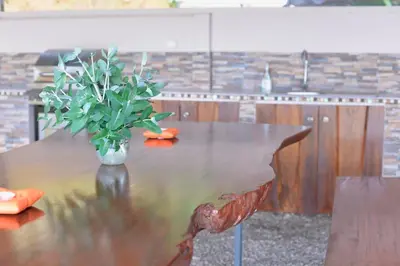 a wooden table with a vase with a plant on it at Supercostarica in Grecia