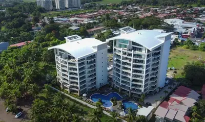 an aerial view of a building in a city at Modern Condominium Beachfront Jaco Beach, Diamante del Sol in Jacó