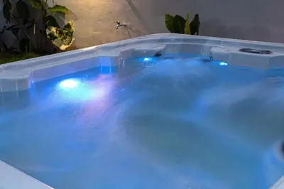 a jacuzzi tub with blue water and lights at Apartamento Lantanas in Palma