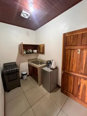 a small kitchen with a sink and a stove at Apartamentos casco in Heredia