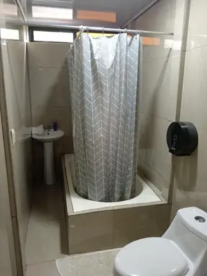 a bathroom with a shower curtain and a sink at Casa Pura Vida Arenal in Tanque
