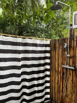 a black and white towel on a wooden fence at Safari tent with private pool close to Manuel Antonio Glamping 2 in Savegre