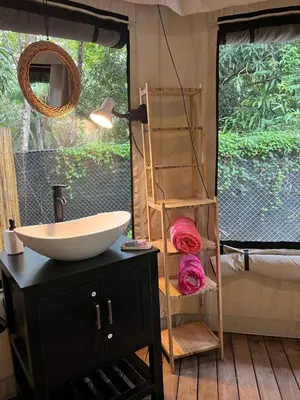 a bathroom with a sink and a mirror at Safari tent with private pool close to Manuel Antonio Glamping 2 in Savegre