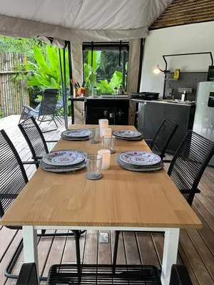 a wooden table with plates and dishes on top of it at Safari tent with private pool close to Manuel Antonio Glamping 2 in Savegre