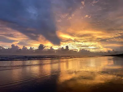 a sunset on a beach with the ocean at Safari tent with private pool close to Manuel Antonio Glamping 2 in Savegre