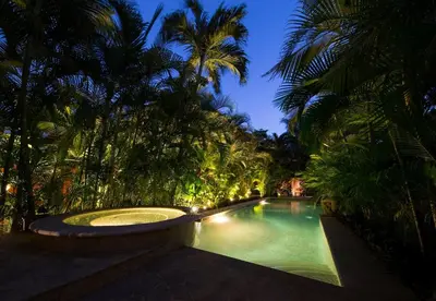 a swimming pool in the middle of a yard with palm trees at Stef Surf Villa El Delfin in Potrero