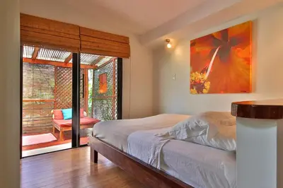 a bedroom with a bed and a large window at Stef Surf Villa El Delfin in Potrero