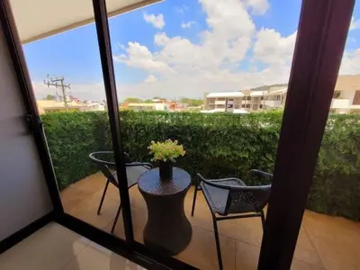 a patio with a table and chairs and a vase with flowers at Walk to Downtown Santa Ana, Near Airport, Lush Gardens, Pool, King Bed, Security in Santa Ana