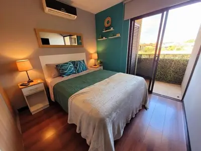a bedroom with a bed and a green wall at Walk to Downtown Santa Ana, Near Airport, Lush Gardens, Pool, King Bed, Security in Santa Ana
