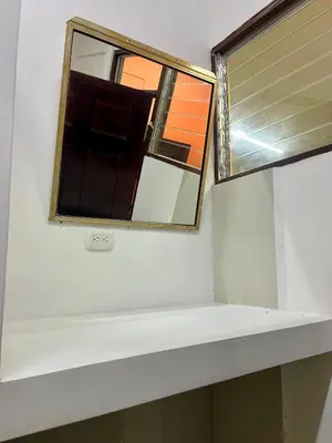 a mirror on top of a white shelf in a bathroom at Pura Vida Stay Liberia in Liberia