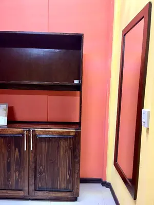 a wooden cabinet in the corner of a room at Pura Vida Stay Liberia in Liberia
