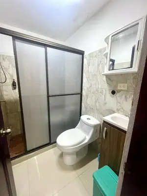 a bathroom with a toilet and a shower and a sink at Pura Vida Stay Liberia in Liberia