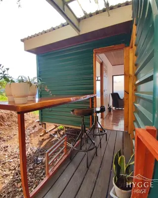 a tiny house with a desk on a deck at Hygge House with a view of the Arenal Volcano and the San Carlos Plain in Vieja