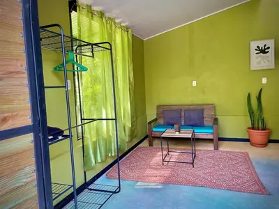 a living room with a bunk bed and a table at green house in Rivas